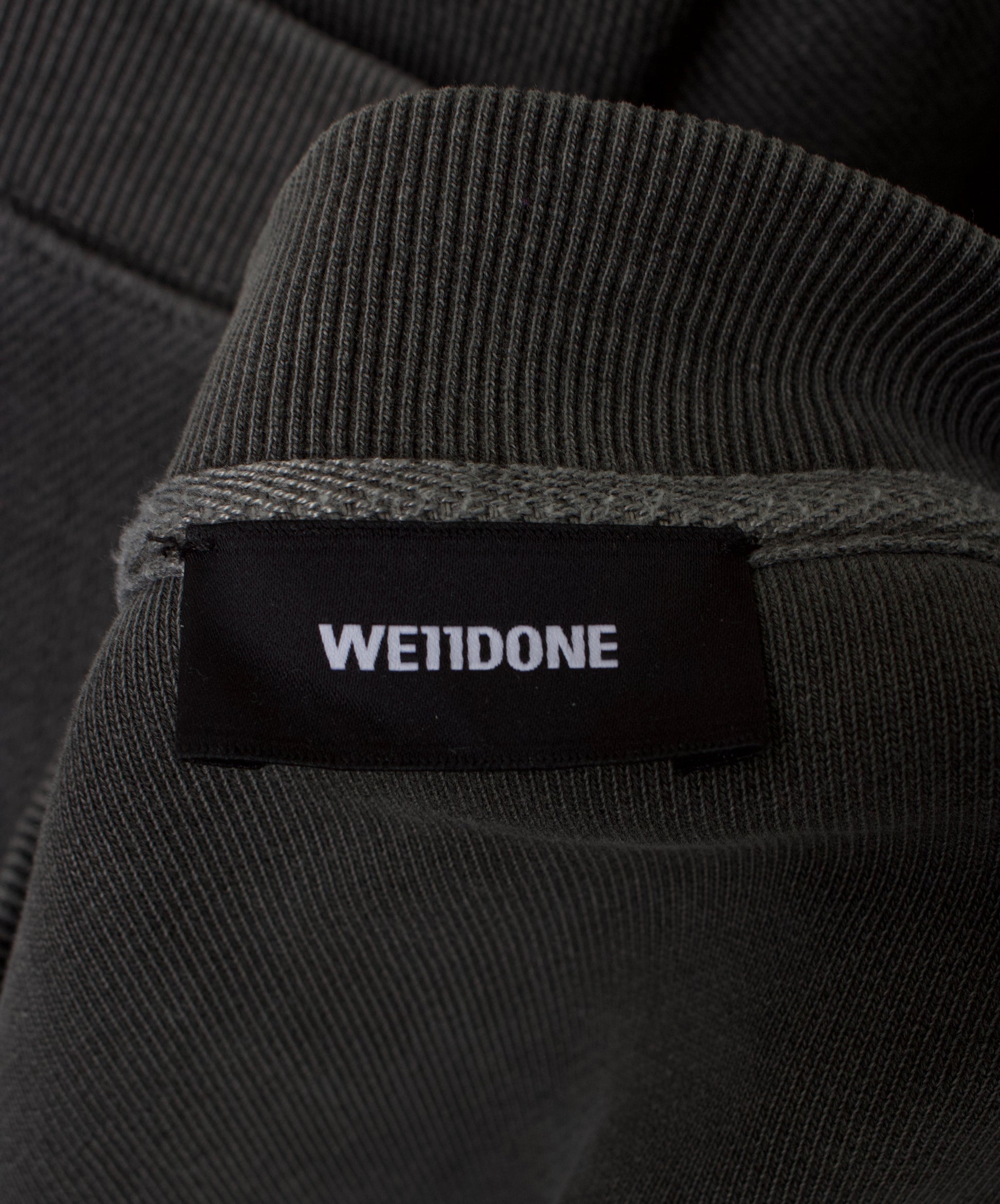 brand tag detail shot WE11DONE Oversized Raglan V-neck Studded Vest