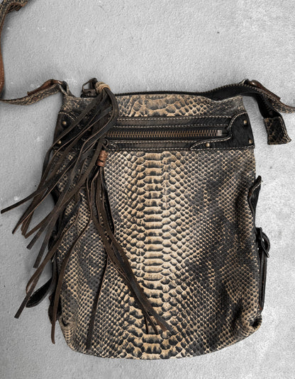 A Kyoji Maruyama Early 00s yellow crocodile embossed leather side bag with a zippered pocket, decorative leather fringe, and long strap is displayed on a gray surface—an elegant piece from the designer brand.