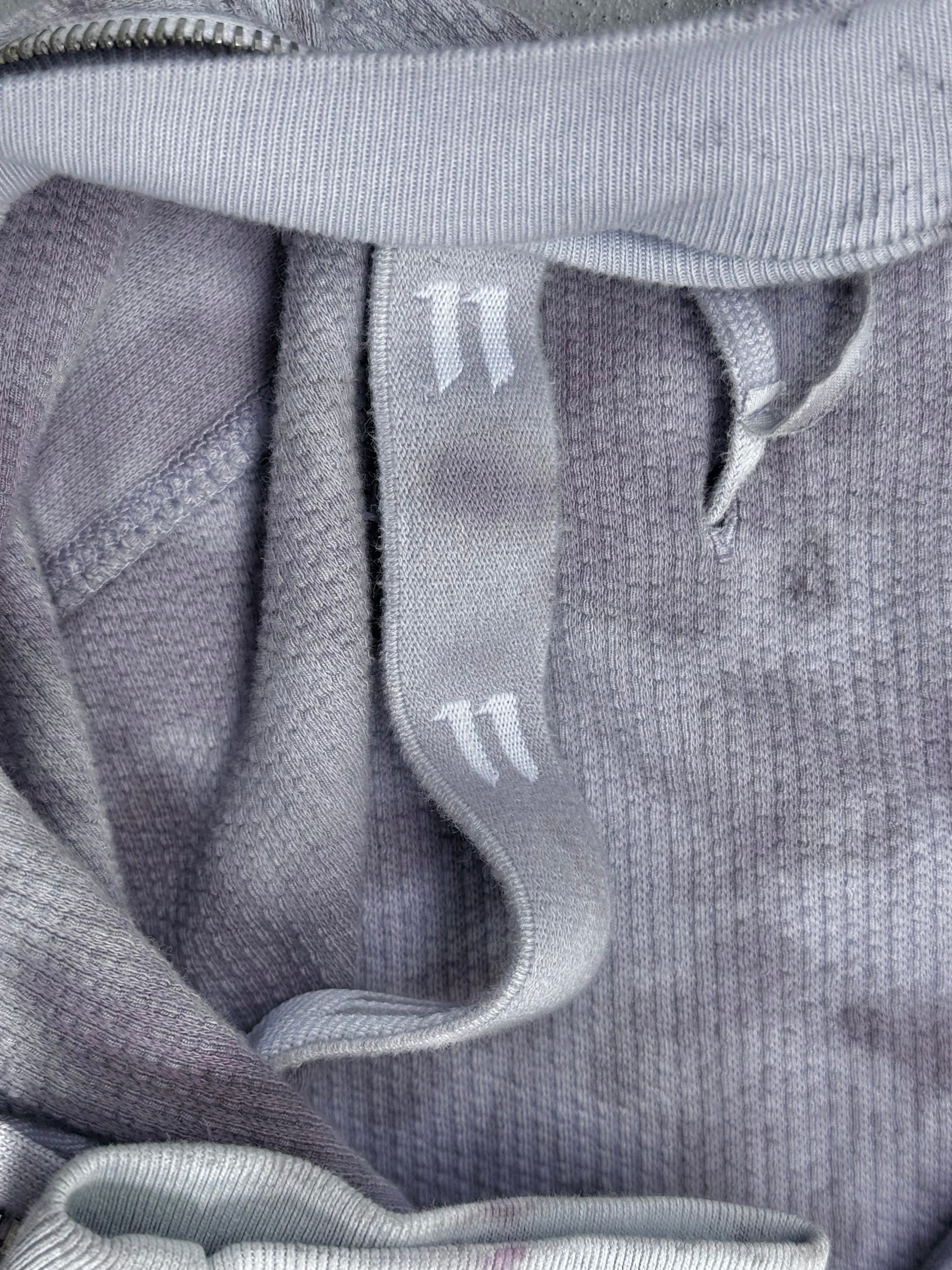 A close-up of the Boris Bidjan Saberi 11 by Boris Bidjan Saberi SS23 ‘Z1-F1235’ hand-dyed convertible hoodie in grey ribbed fabric, Size XL, featuring matching drawstrings with two white lines near the ends and a slim fit.