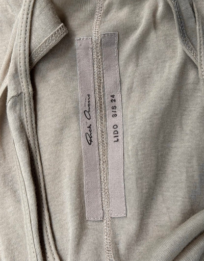 A pearl sheer tanks inner label features Rick Owens on one tag and LIDO SS24 with size SIS XS on the other, sewn onto the fabric—a subtle nod to avant-garde fashion’s attention to detail.