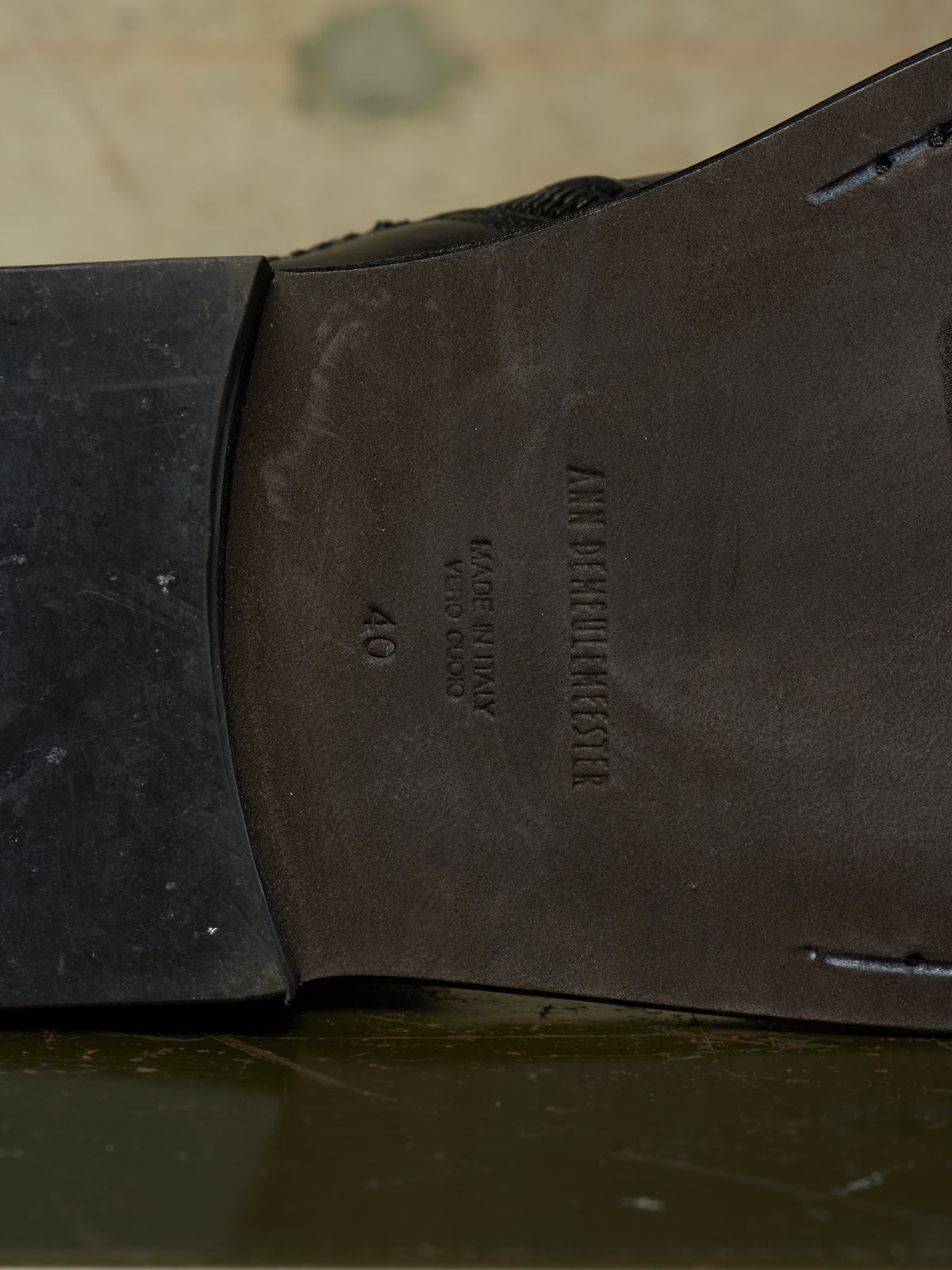Close-up of the underside of a dark brown leather shoe sole, showing the brand name 'AMERICAN STAR' and size '40' embossed on the heel bed.