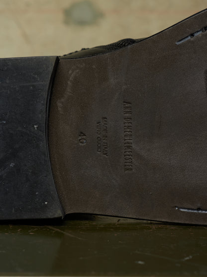 Close-up of the underside of a dark brown leather shoe sole, showing the brand name 'AMERICAN STAR' and size '40' embossed on the heel bed.