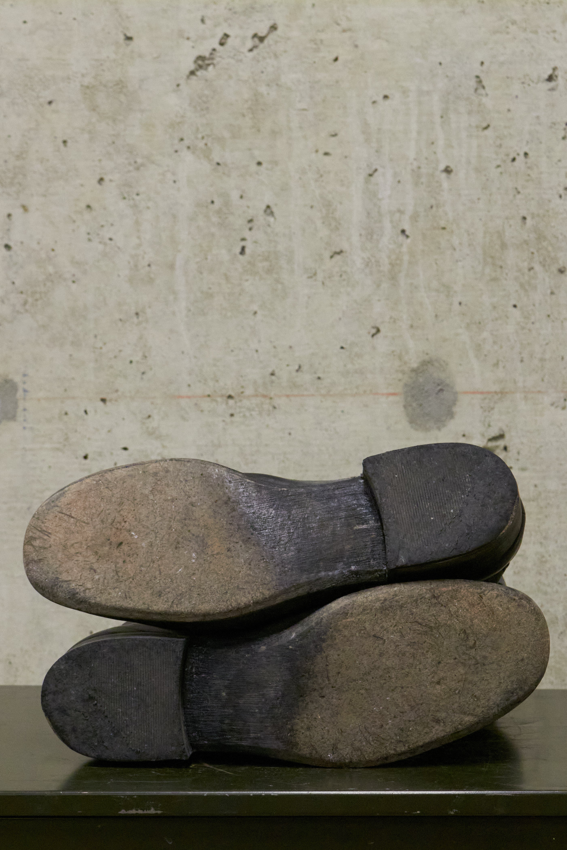 Pair of worn shoes on a concrete surface