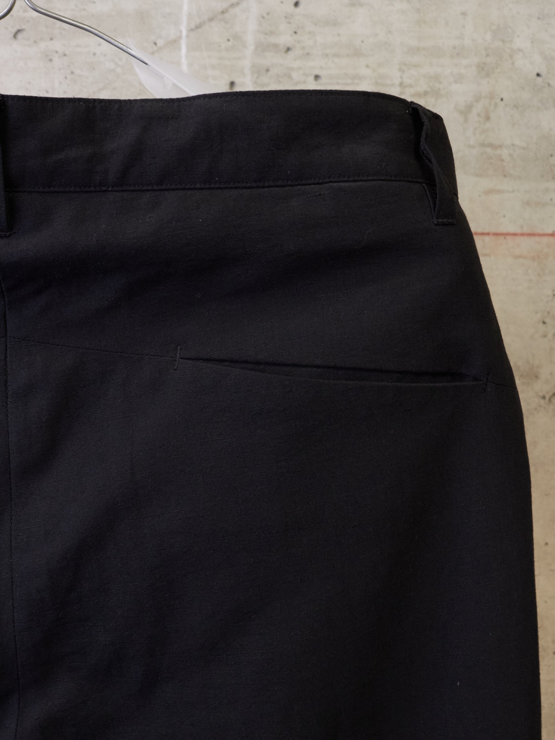 Close-up of black pants on a textured surface