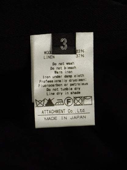Clothing label with care instructions on a black background