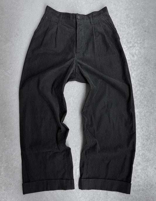 Black ribbed pants on a gray background