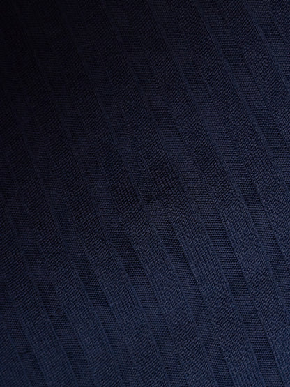 A close-up of dark navy blue textured fabric with a subtle diagonal woven pattern.