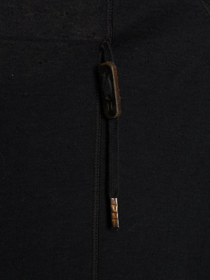 Close-up of a black zippered garment with a dark brown zipper pull tab and a small metallic gold accent near the bottom of the zipper pull.