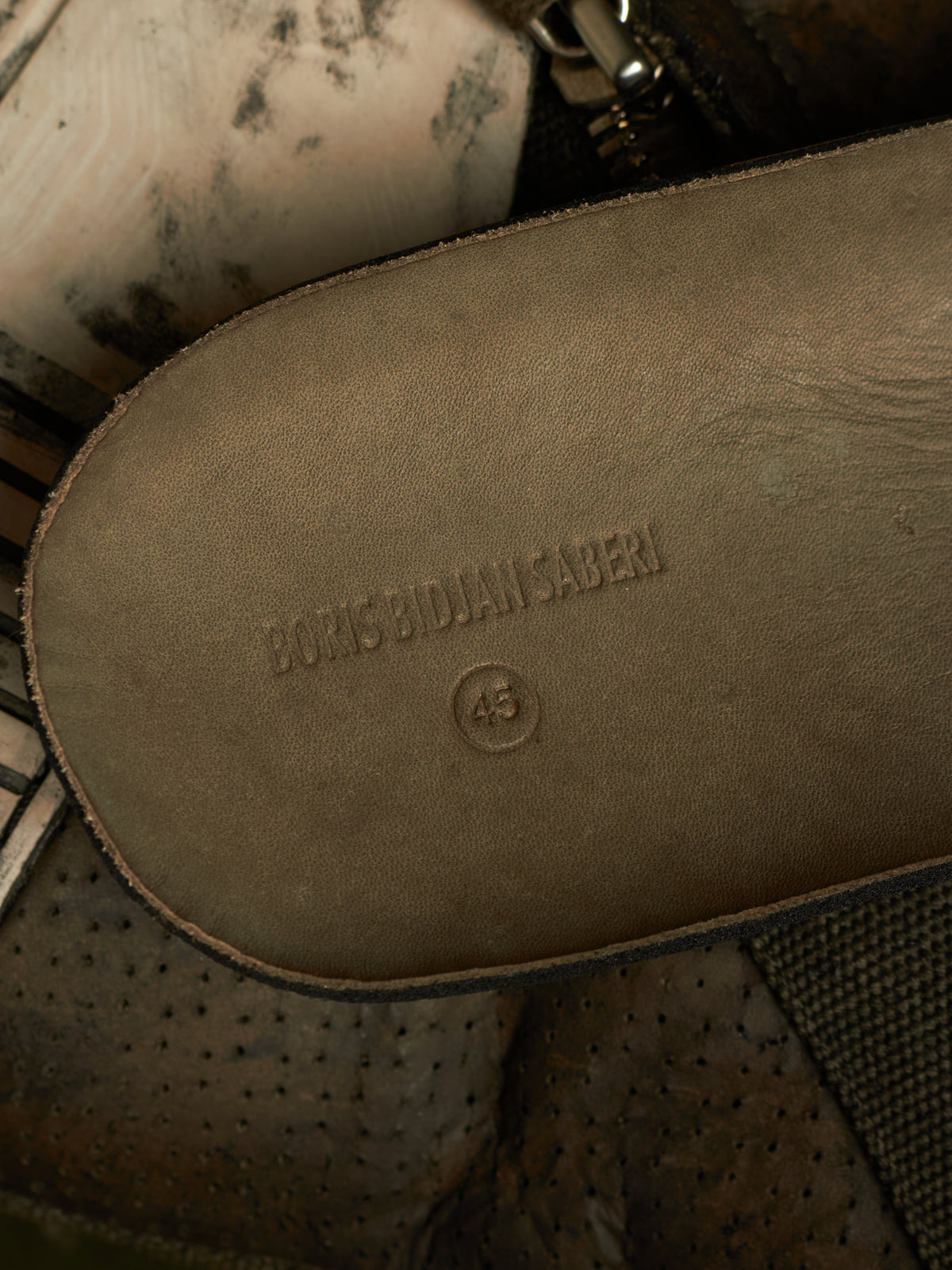 Close-up of the sole of a brown leather shoe or boot, embossed with the brand name 'BORIS BIODAN SABEN' and size '43'.
