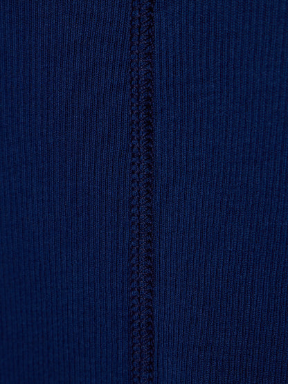 Close-up of a dark blue ribbed knit fabric with a vertical seam running down the center.