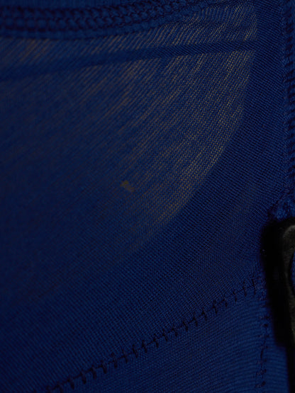 Close-up of a dark blue mesh fabric with visible stitching and a small black hook or fastener on the right side.