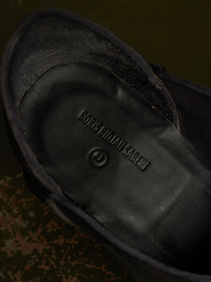 Close-up of the black suede and leather interior of a shoe, showing the embossed brand name BONES OF MAN SABERI.
