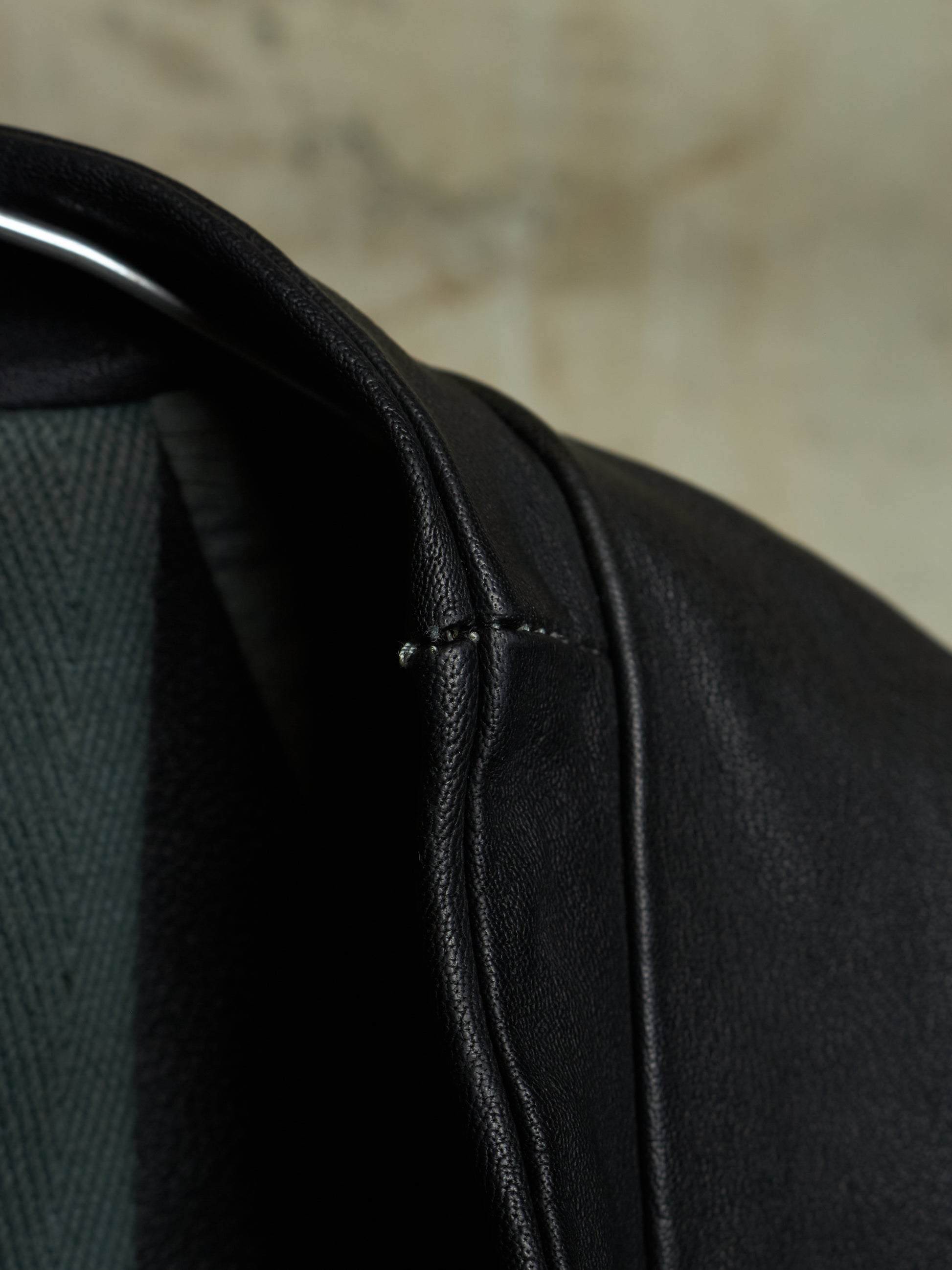 Close-up of a black leather jacket with a blurred background