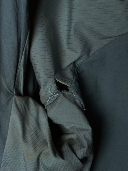 Close-up of a textured dark green fabric with folds