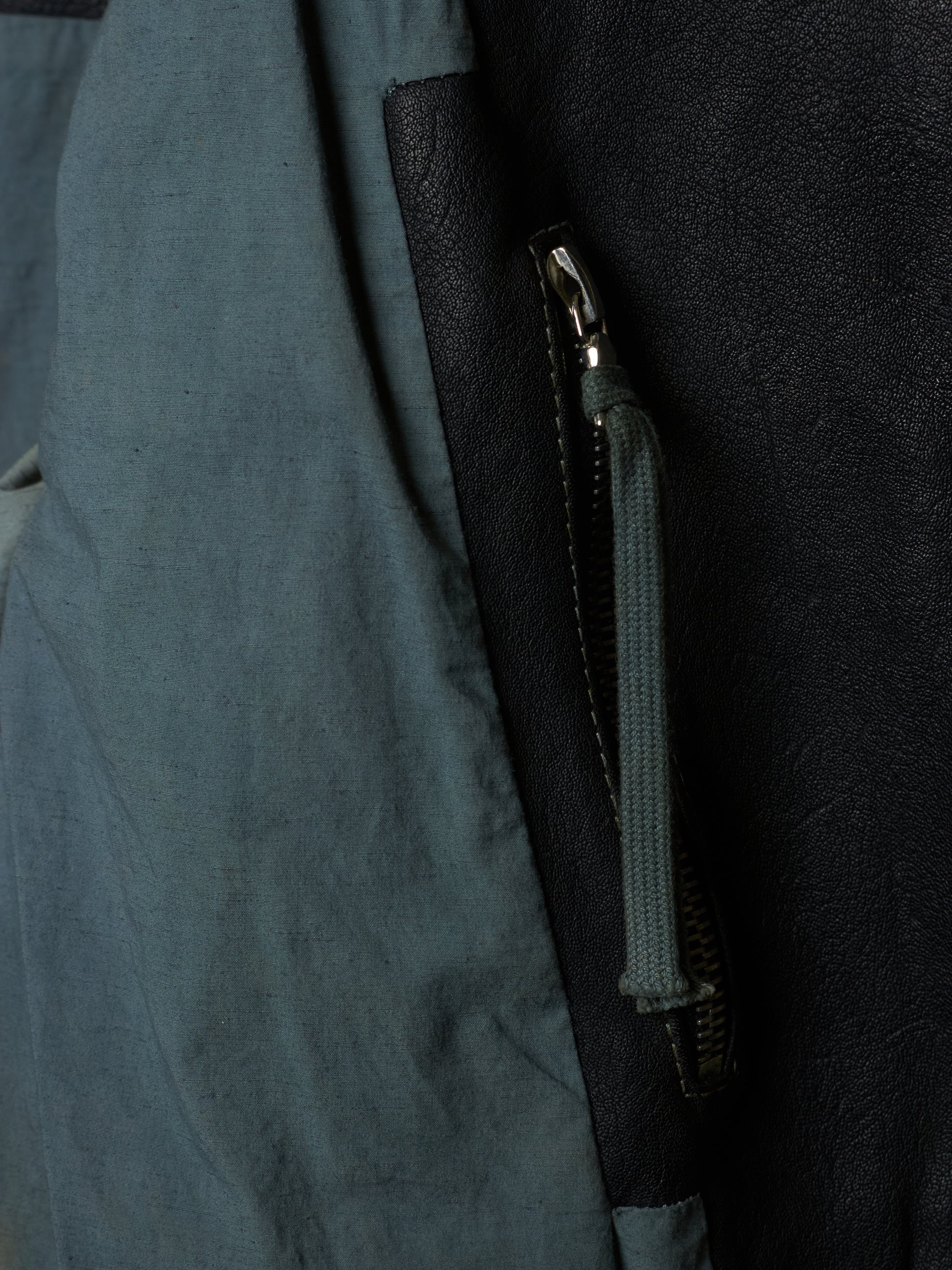 Close-up of a zipper on a dark blue fabric surface