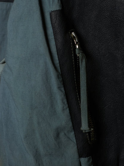 Close-up of a zipper on a dark blue fabric surface