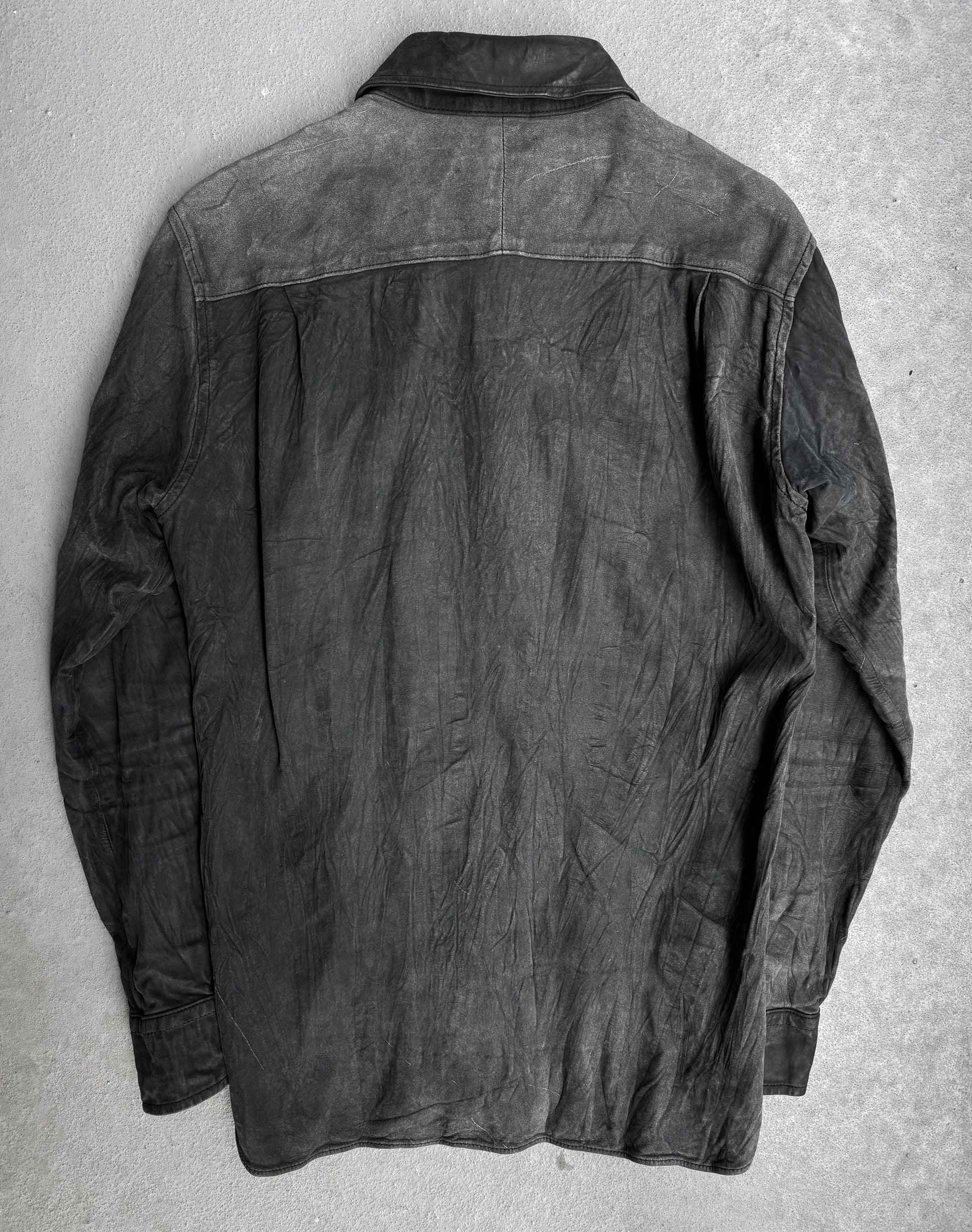 The Kyoji Maruyama Early 00s Washable Wrinkle Nubuck Leather Shirt features a weathered black finish with creases and faded areas, laid flat to display the back—reflecting minimalist Japanese design.