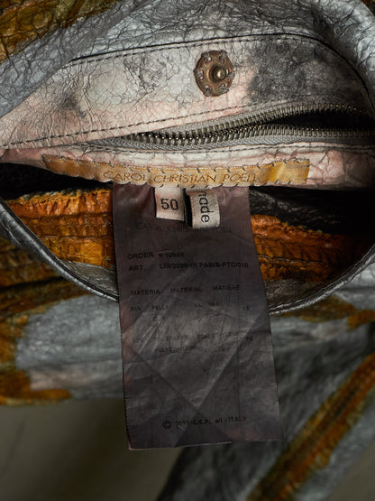 Close-up of the interior of a textured leather bag showing a zipper, interior lining, a sewn-in size tag reading 50, and a paper brand tag for Carol Christian Feen.