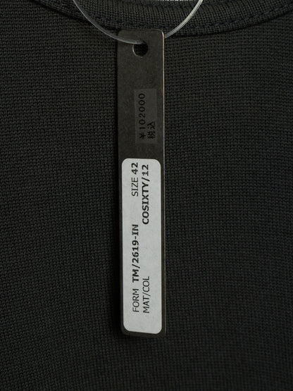 Close-up of a black ribbed knit garment with a hanging size tag reading COSIXY/ZZ, SIZE 42, and other printed details.