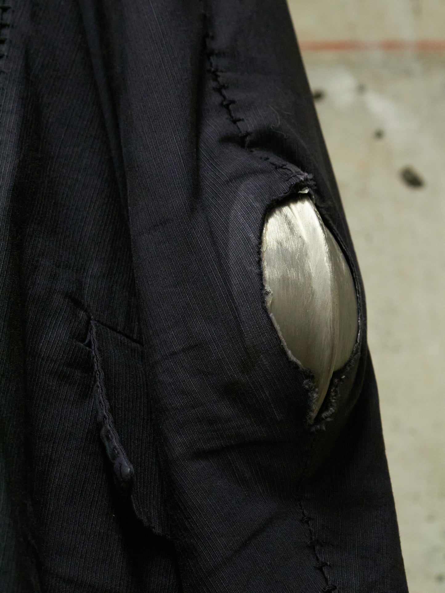 Close-up of a black jacket with a patch on an urban background