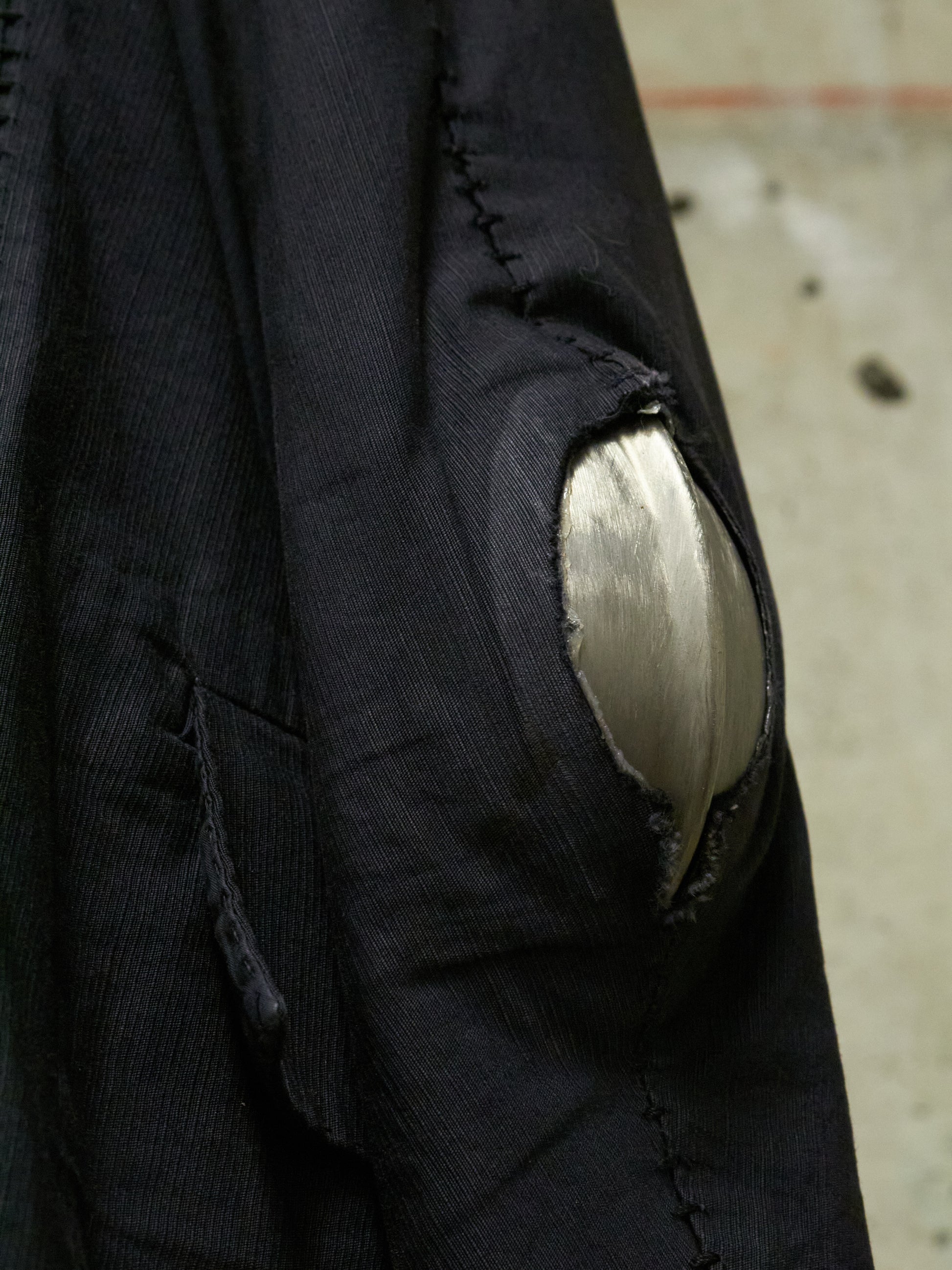 Close-up of a black jacket with a patch on an urban background