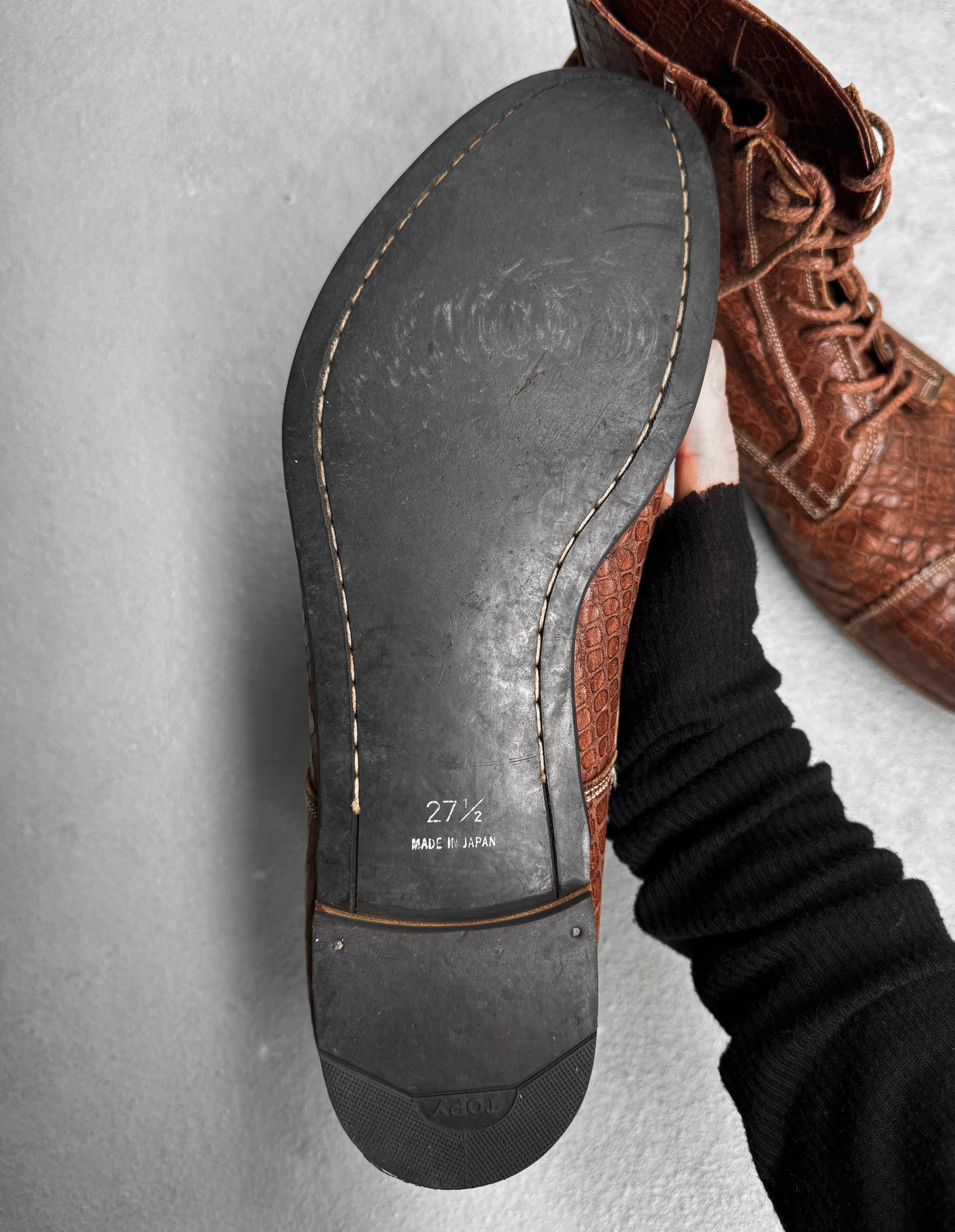 A close-up of the sole of Mihara Yasuhiro Early 00s Python Embossed Cow Leather Pointy Toe Boots highlights visible stitching and a MADE IN JAPAN stamp, showcasing the avant-garde craftsmanship of the renowned Japanese designer.