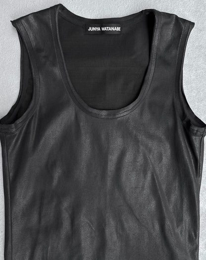 A Junya Watanabe SS23 Waxed Scoop-neck Tank Top in black, size S. This slim-fit sleeveless piece features a shiny finish and is shown laid flat on a light gray surface in flawless condition. Brand label inside the collar.