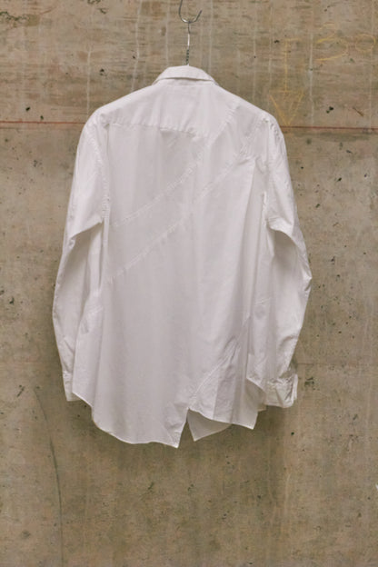 White shirt hanging on a textured wall
