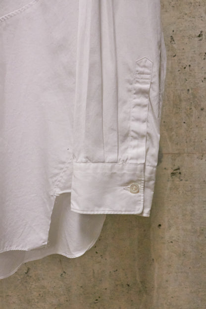 Close-up of a white shirt cuff on a concrete surface