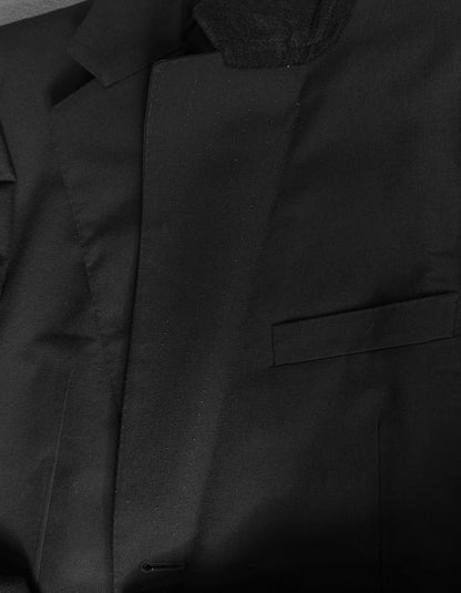Close-up of a black jacket with a textured hood and pocket detail.