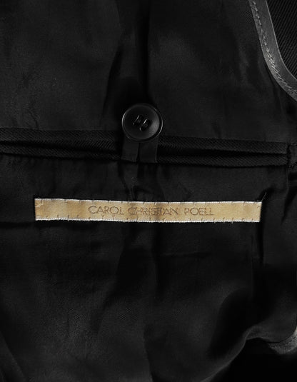 Close-up of a black garment with 'CAROL CHRISTIAN POLO' label.