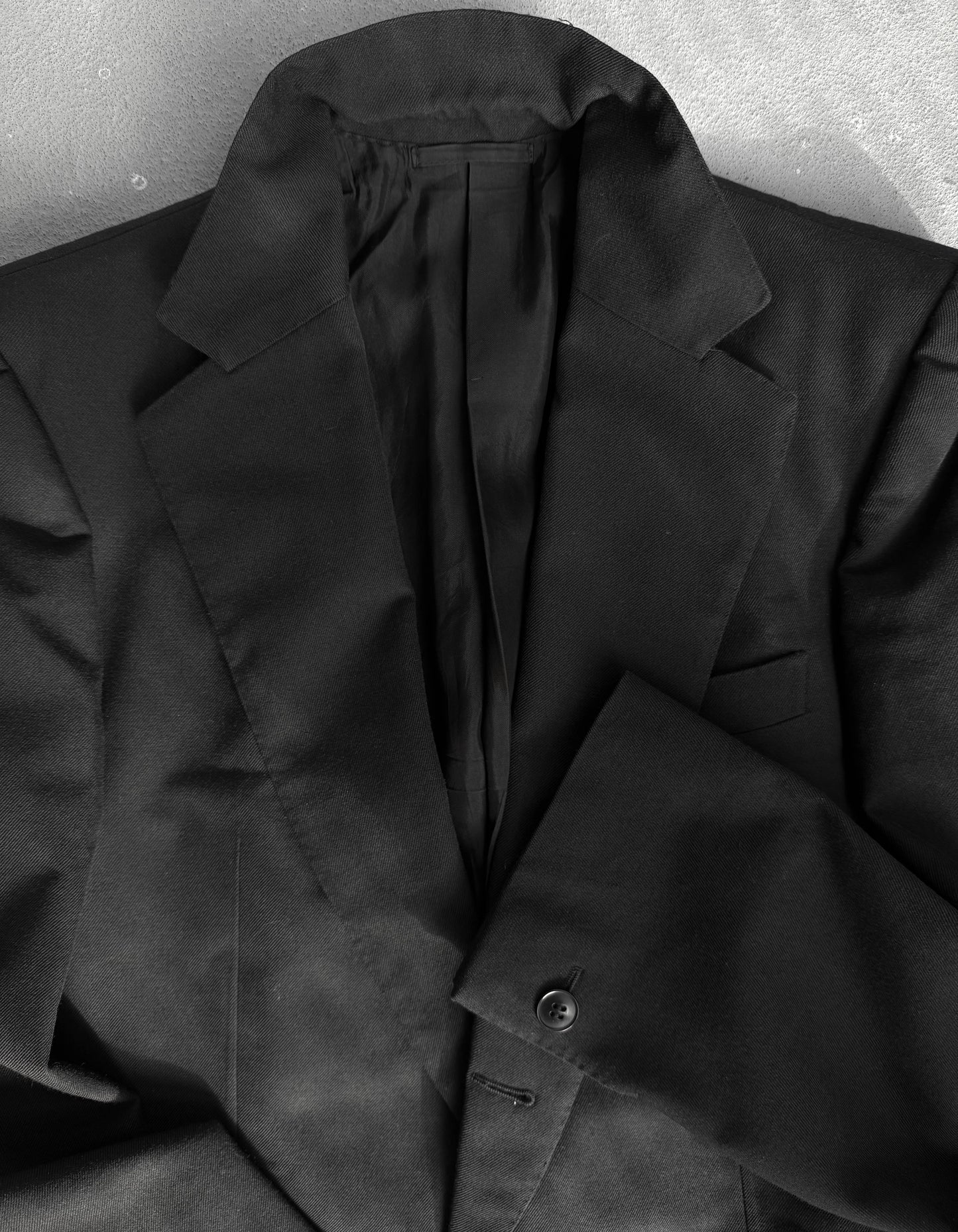 Black coat on a textured gray background