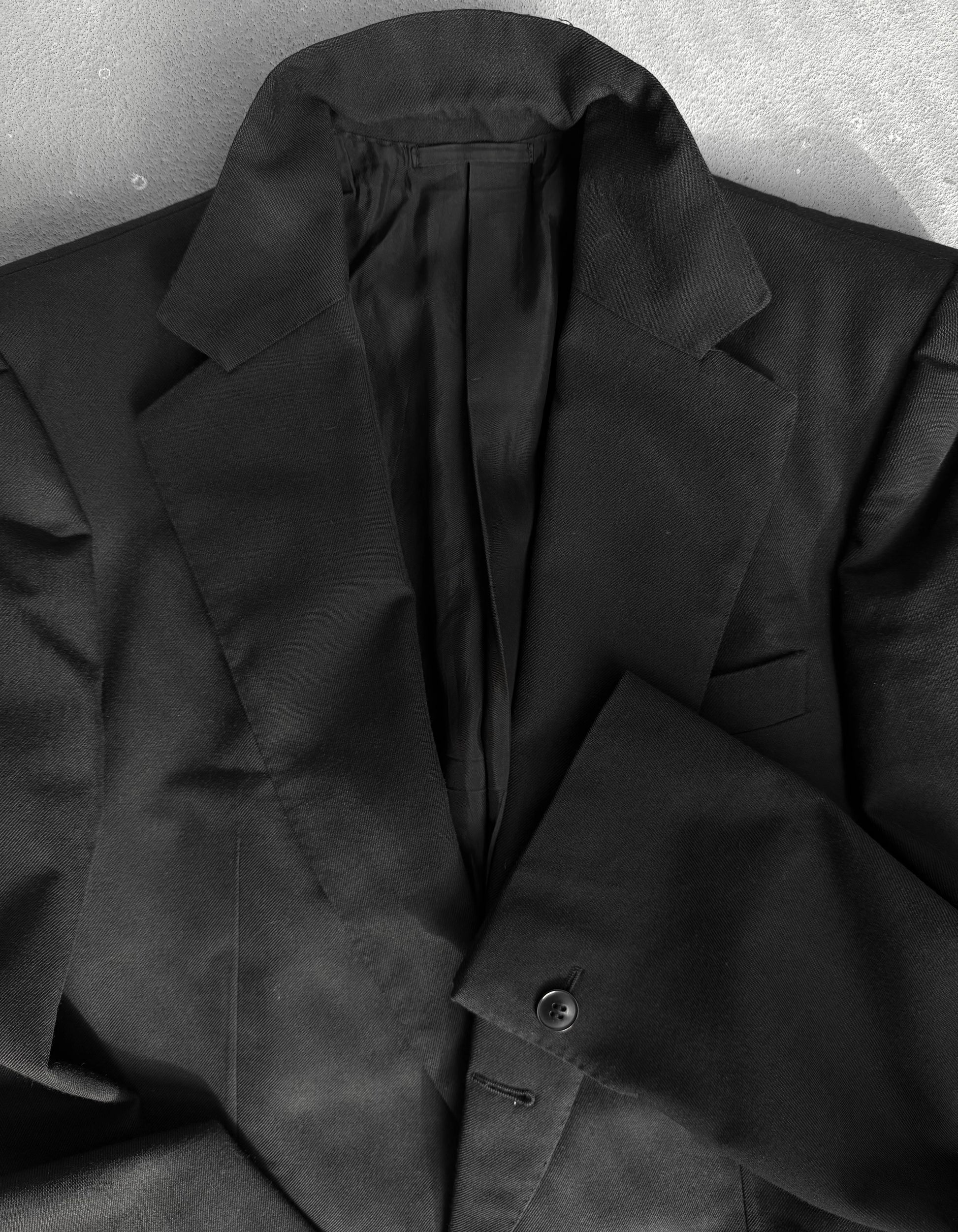 Black coat on a textured gray background