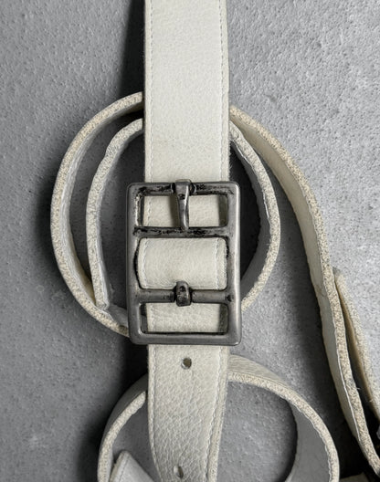 Light gray leather belt with a silver buckle on a gray background