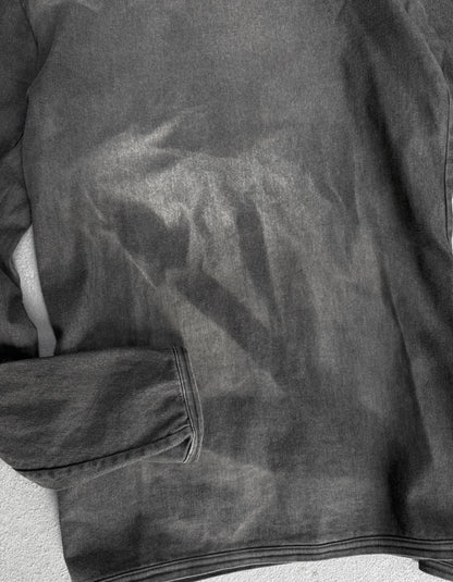 Close-up of a dark gray jacket with a textured surface.