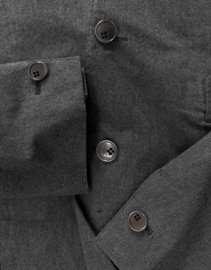 Close-up of a gray coat with buttons on a dark background