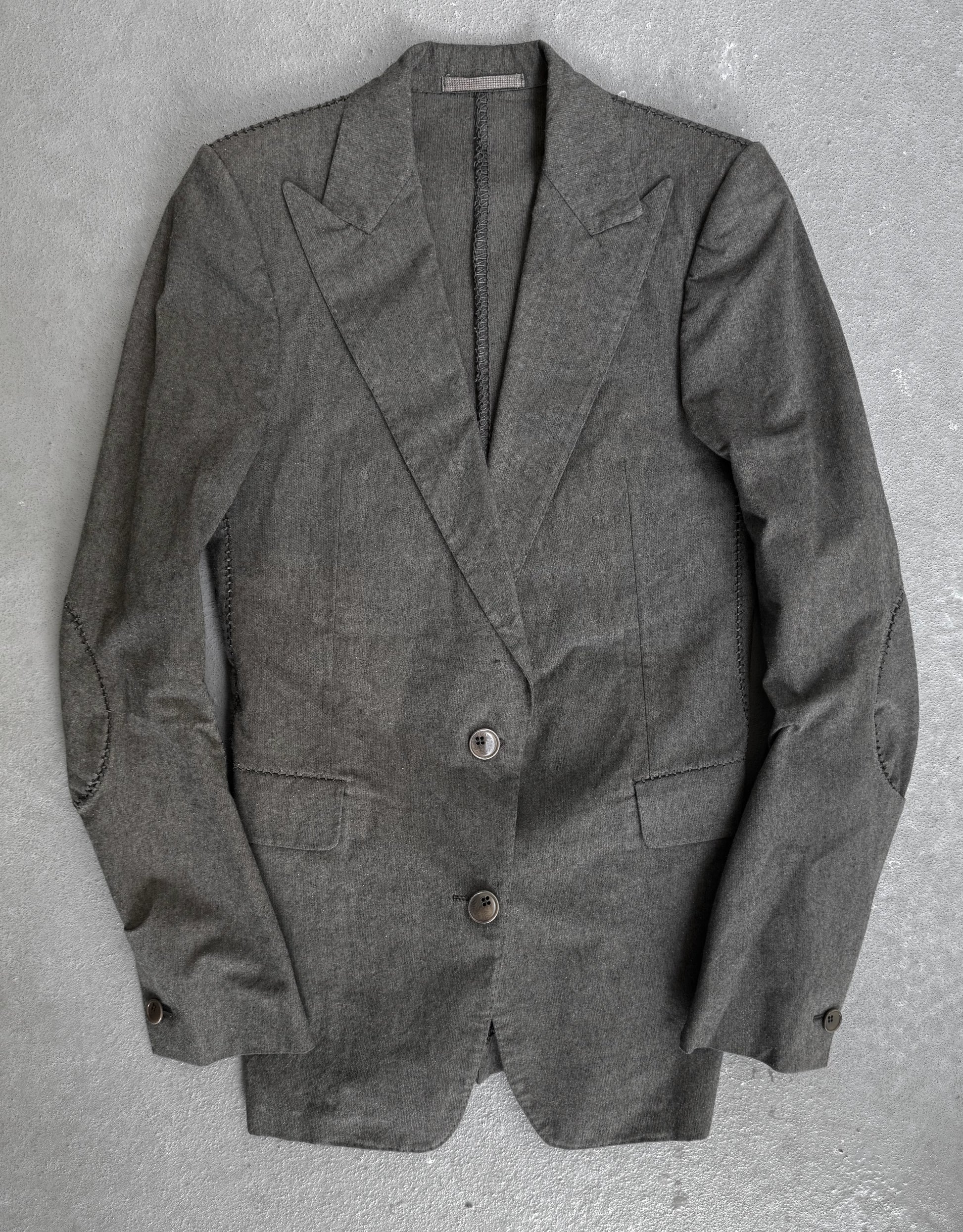 Gray blazer on a textured gray background