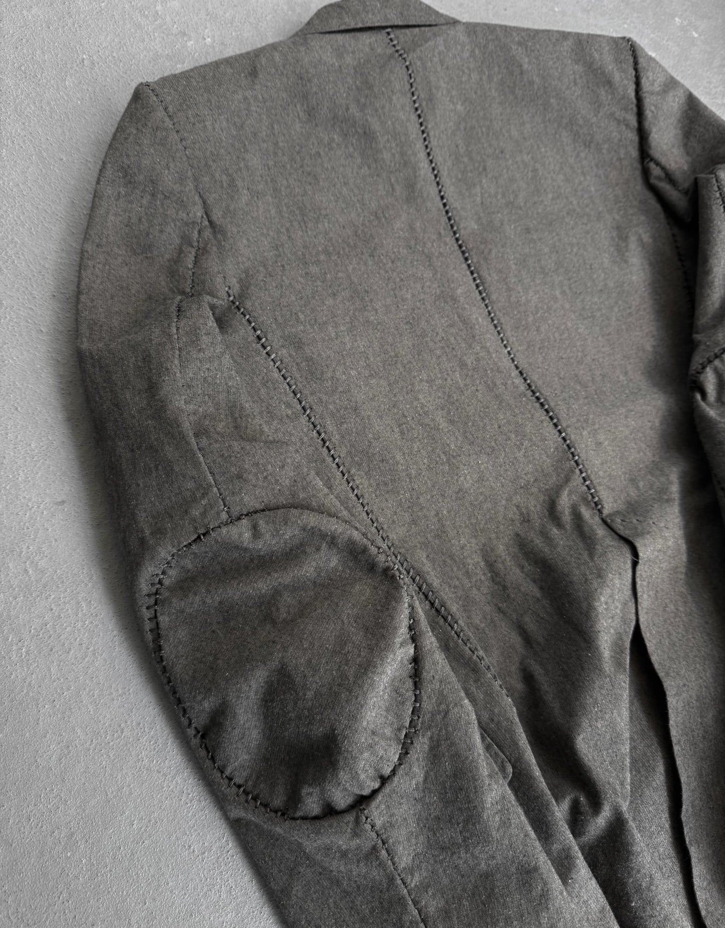 Gray jacket with elbow patches on a gray background