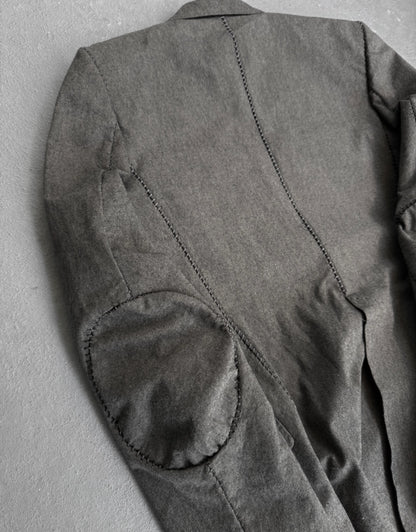 Gray jacket with elbow patches on a gray background