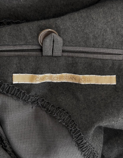 Close-up of a dark gray bag with a visible brand label.