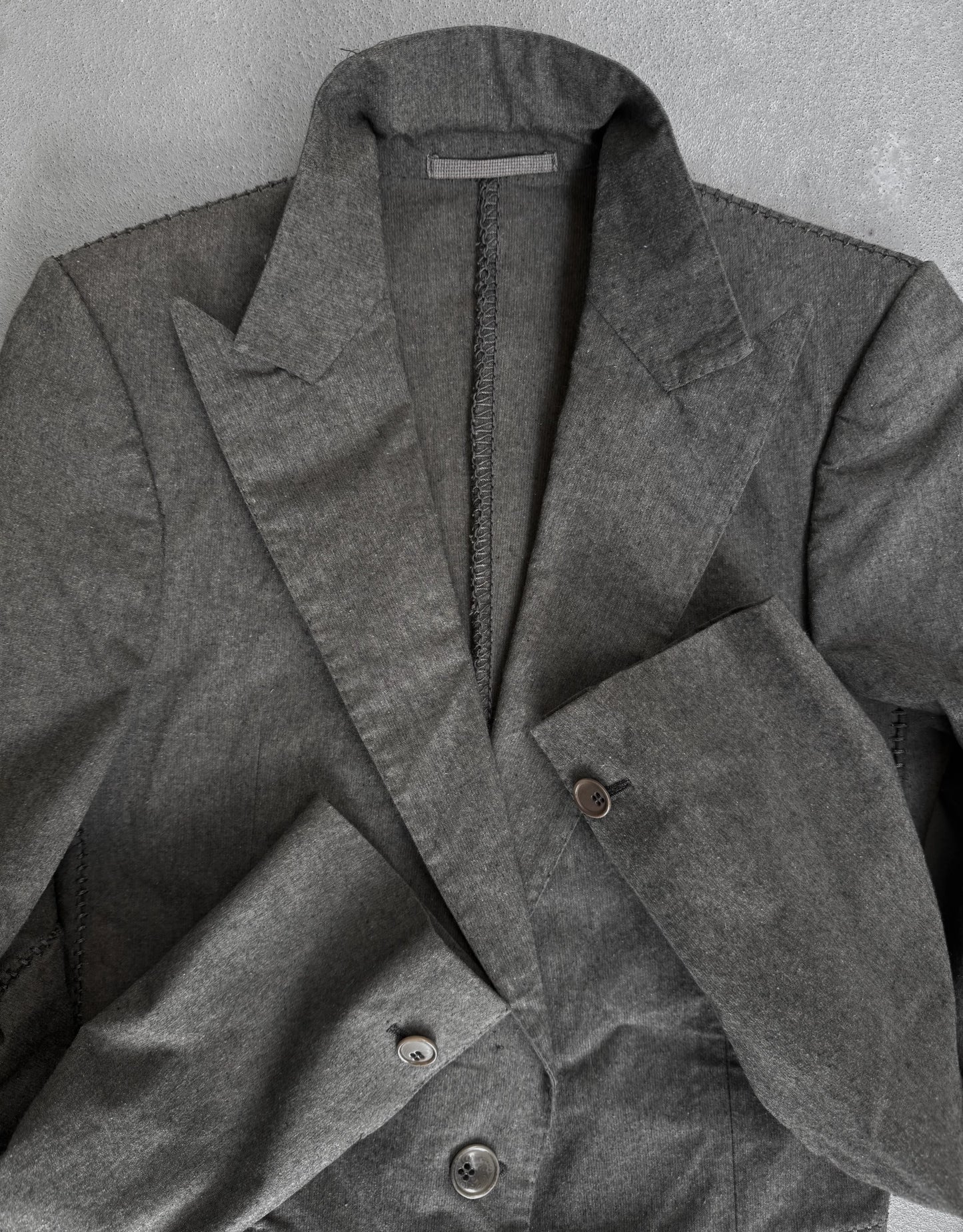 Gray coat with buttons on a gray background