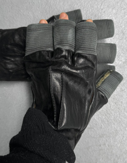 Black leather gloves with gray finger tips on a neutral background