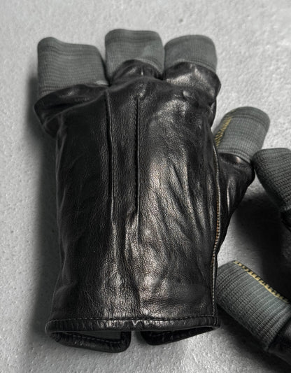 Black leather glove with gray lining on a light gray background