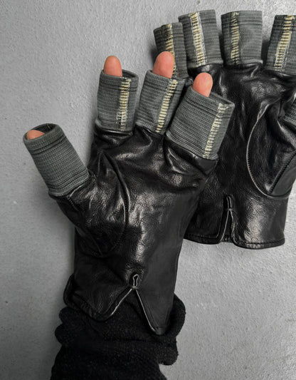 Black leather gloves with gray wristbands on a gray background