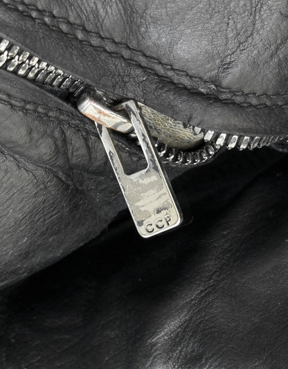 Close-up of a zipper on a black leather surface