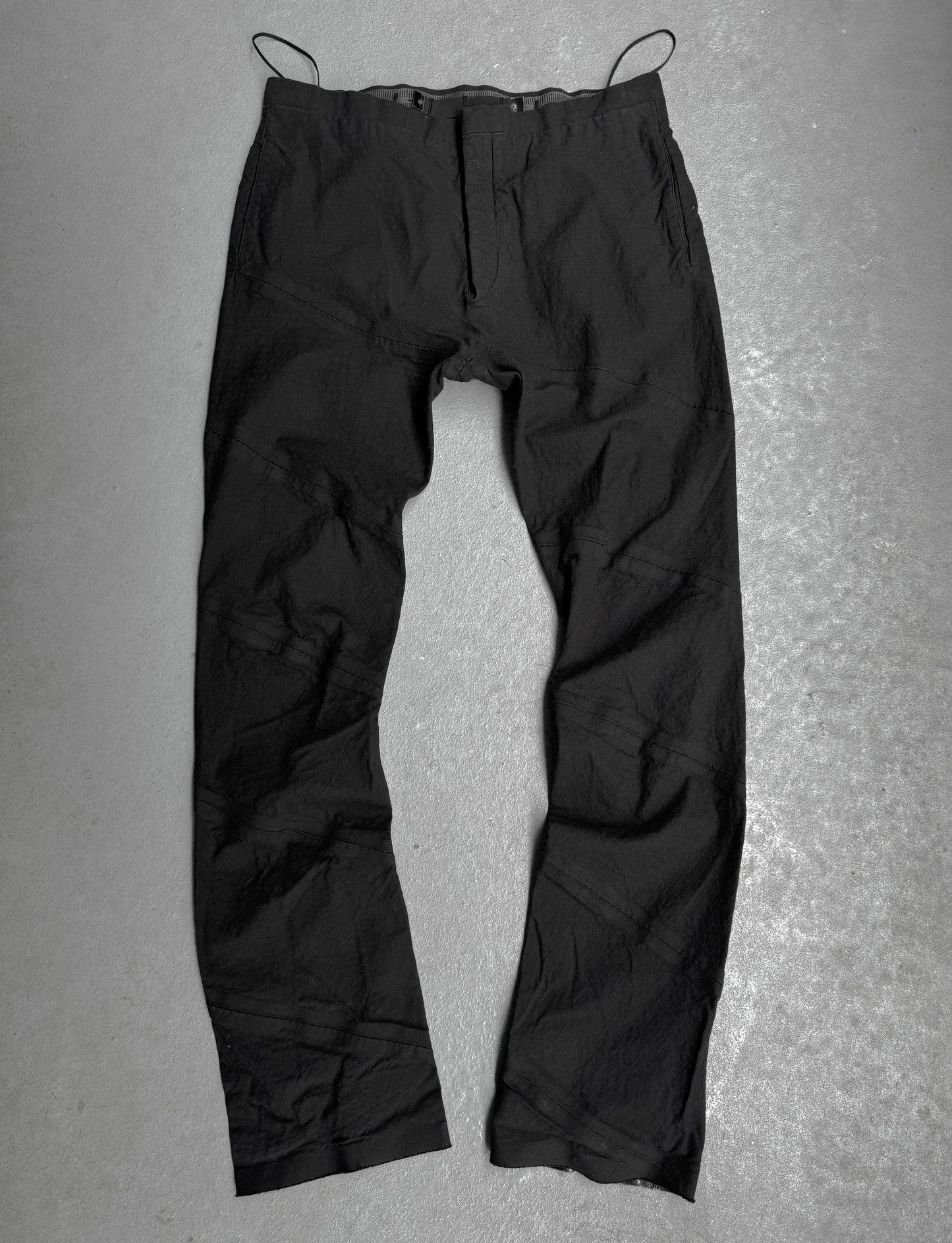 Black pants on a gray textured background