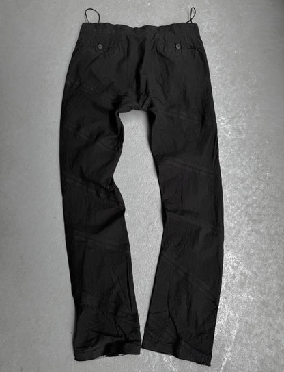 Black pants on a textured gray surface