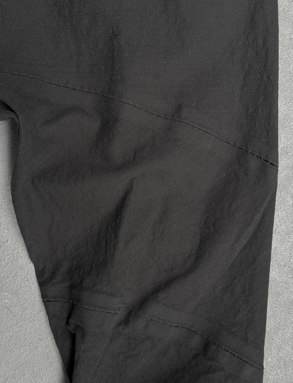Close-up of black pants on a gray background