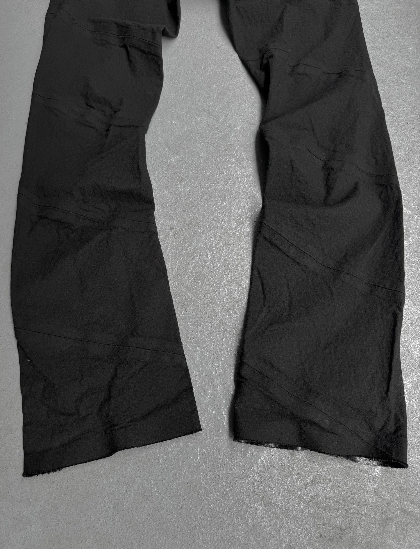 Black pants on a gray textured surface