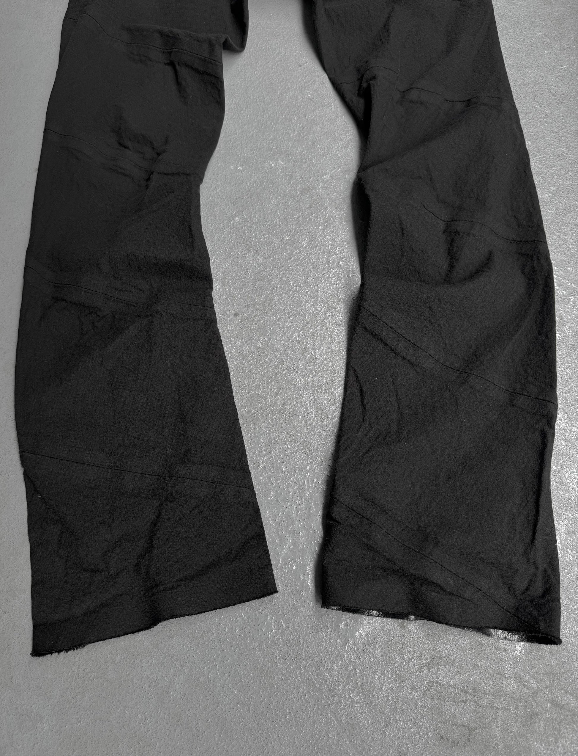 Black pants on a gray textured surface